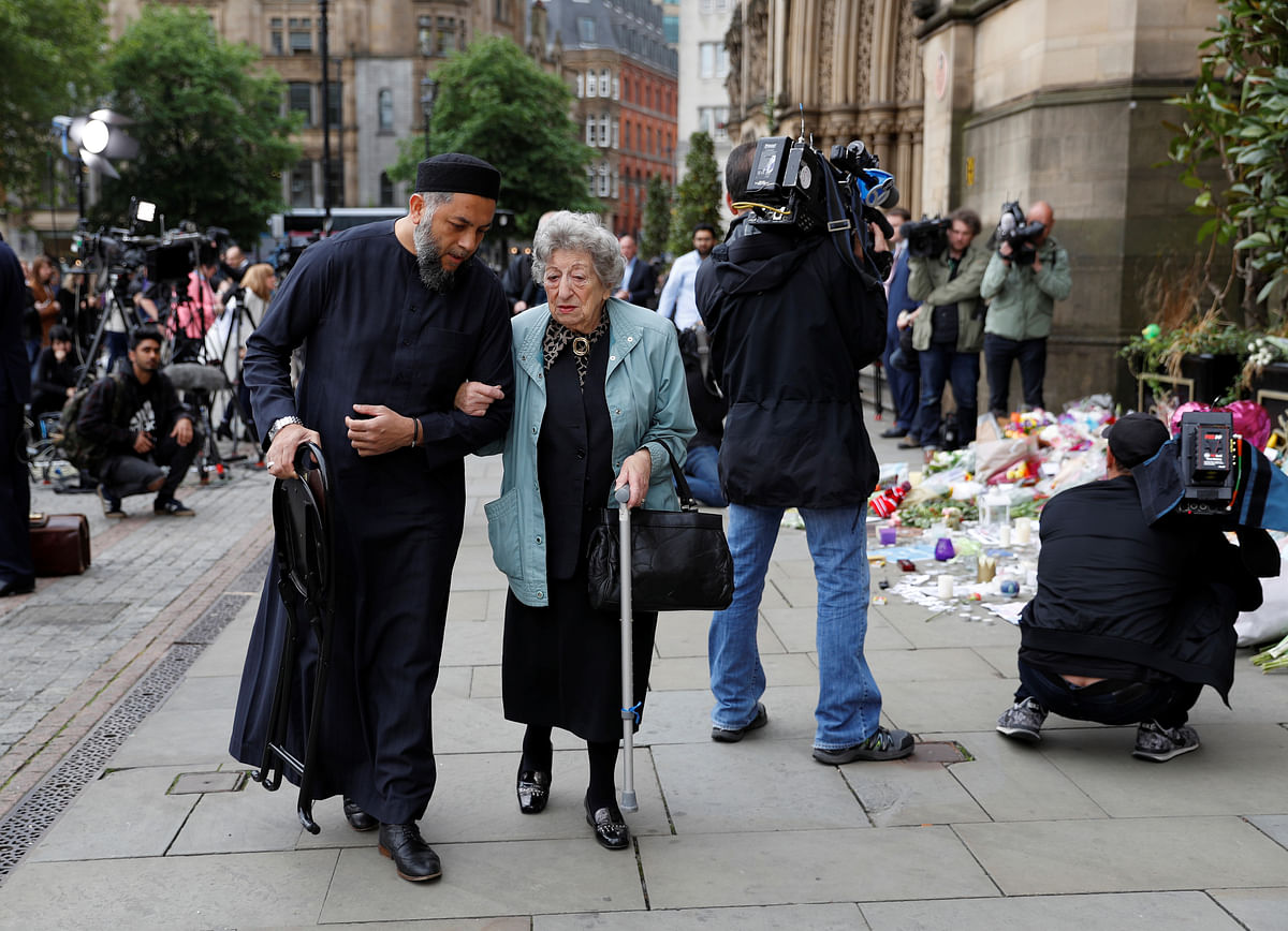 Sadiq Patel comforted Renee Rachel Black, who looked visibly upset at the floral vigil in Albert Square.