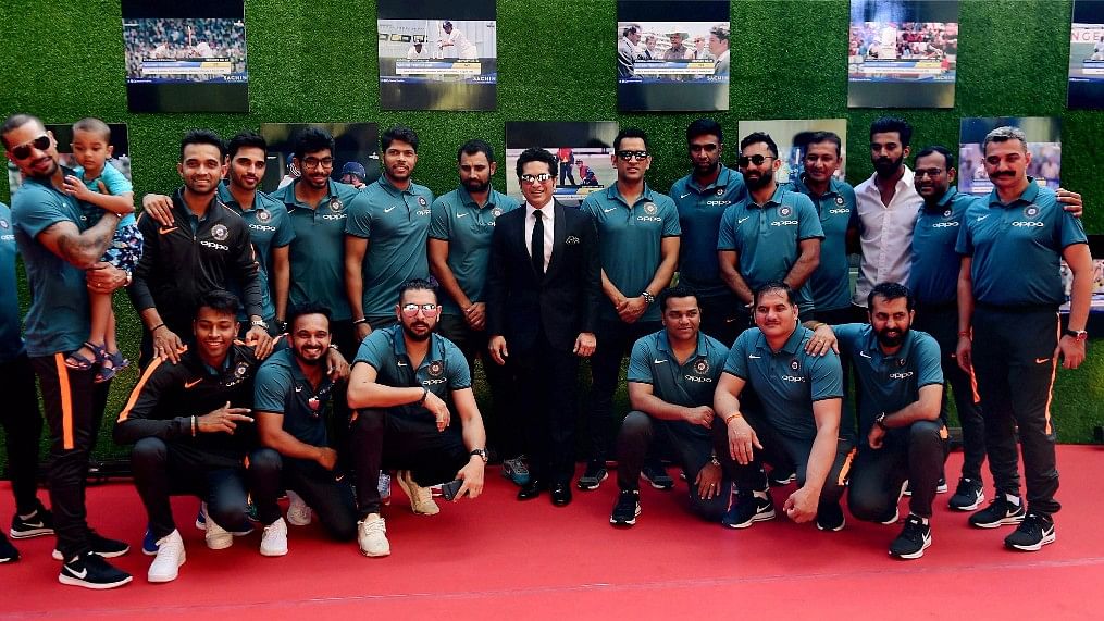 Sachin Tendulkar poses for a picture with the Indian cricket team at his film’s premiere. (Photo: PTI)