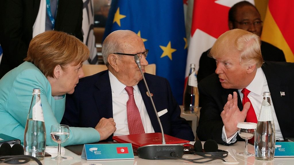 Donald Trump, Angela Merkel speak with Tunisian President Beji Caid Essebsi as they attend a round table meeting of G7 leaders. (Photo: AP)