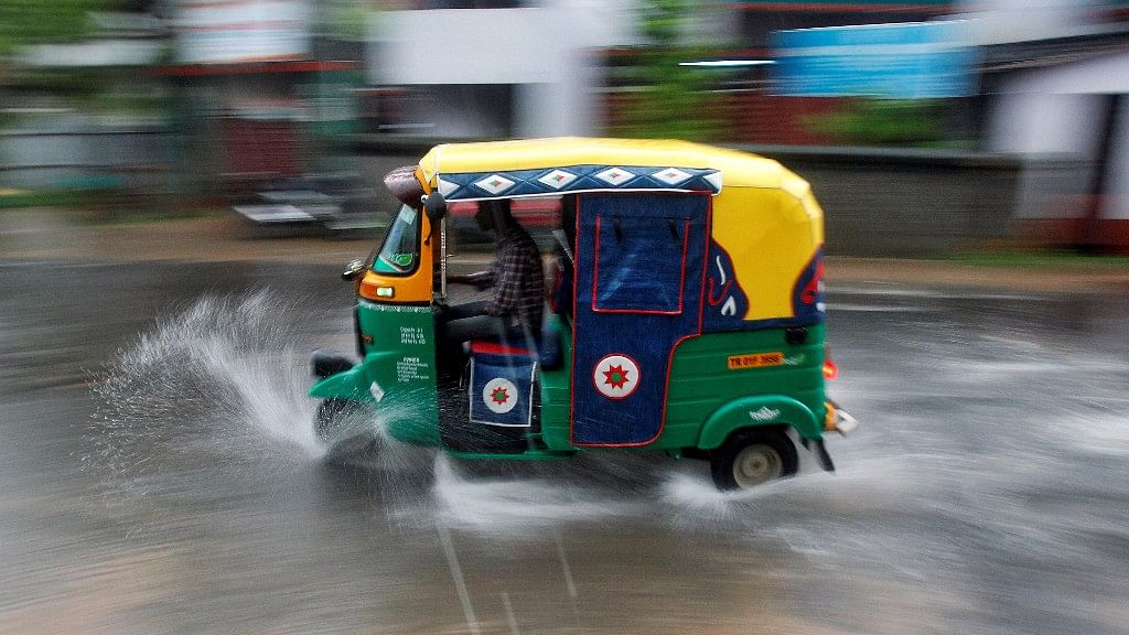 A person drives an auto rickshaw through heavy rains in Agartala,  1 June 2017.&nbsp;
