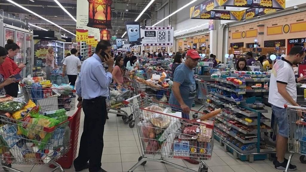 In this photo provided by Doha News, shoppers stock up on supplies at a supermarket in Doha on 5 June after Saudi Arabia closed its land border with Qatar. (Photo: AP)