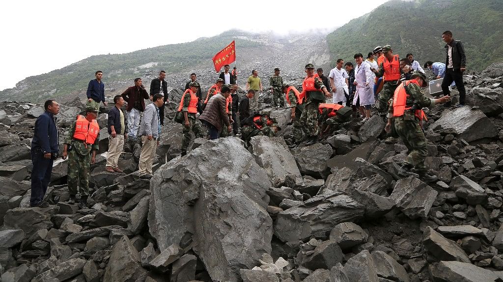 In this photo released by China’s Xinhua News Agency, emergency personnel can be seen at work at the site of a landslide in China’s Sichuan Province on Saturday. (Photo: Reuters)