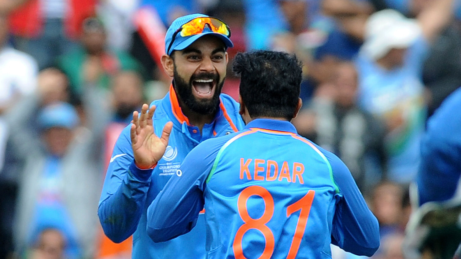 Virat Kohli celebrates a wicket with Kedar Jadhav. (Photo: Reuters)