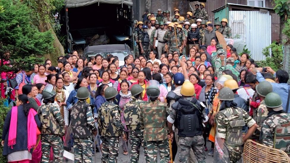 Security forces personnel trying to control woman Gorkha Janamukti Morcha (GJM) supporters during a protest at their office Patlebash in Darjeeling. (Photo: PTI)