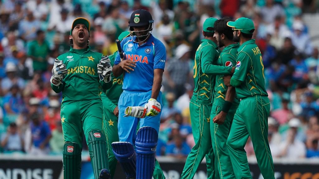 

Pakistan’s captain Sarfraz Ahmed, right, celebrates the dismissal of India’s Ravichandran Ashwin, left, during the ICC Champions Trophy final. (Source: AP)