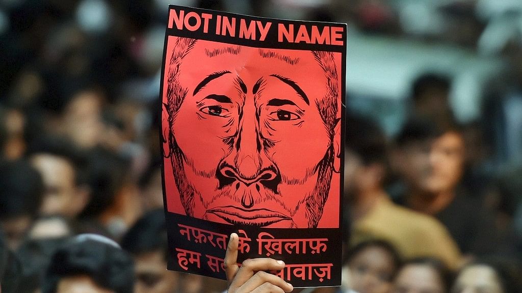 

A protester holds up a “Not in My Name” placard at Jantar Mantar in New Delhi.