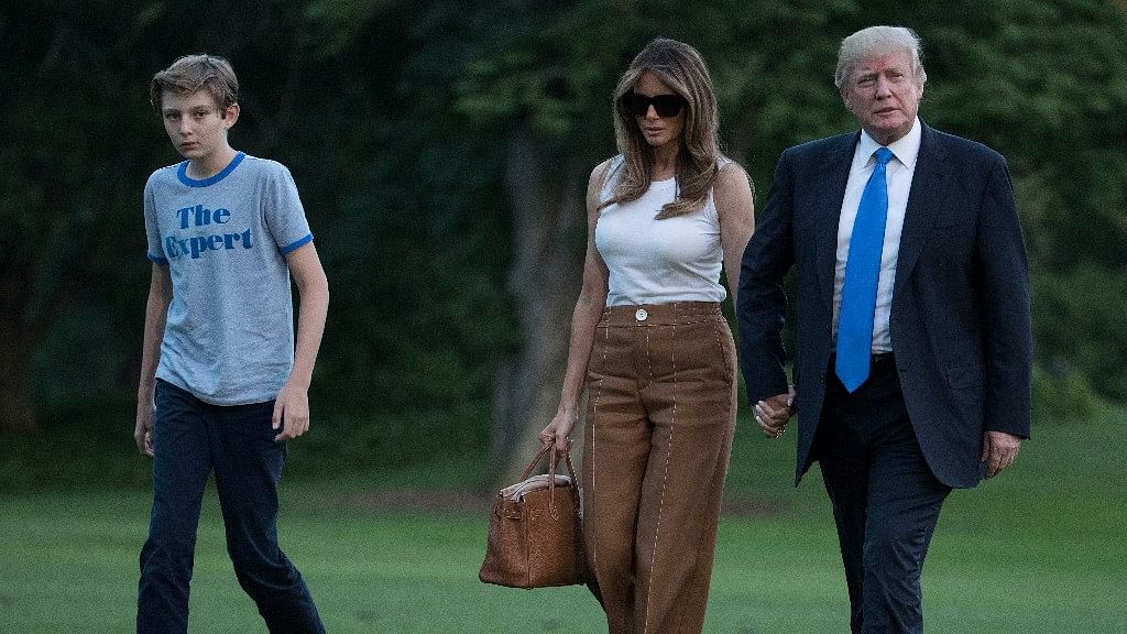 President Donald Trump, First Lady Melania Trump, and their son and Barron Trump walk from Marine One across the South Lawn to the White House in Washington on Sunday. (Photo: AP)
