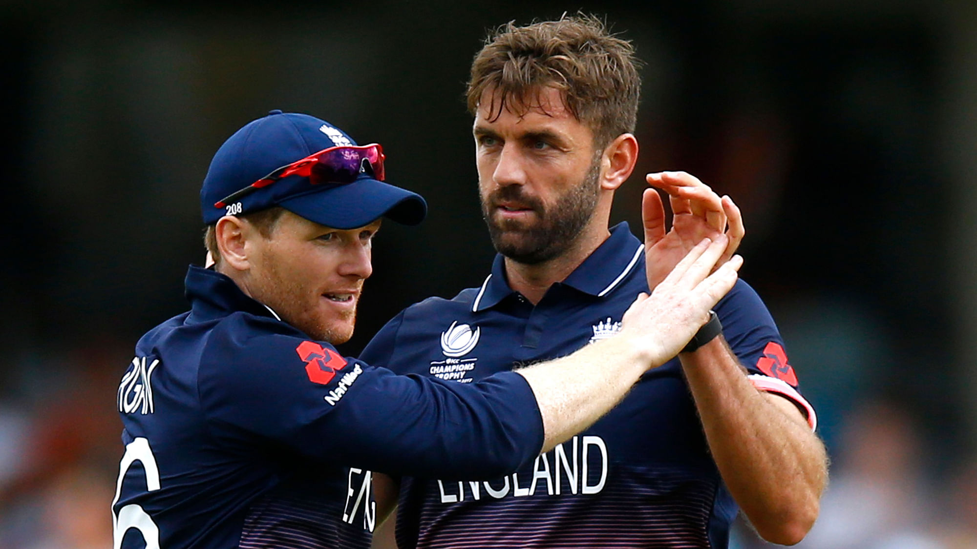  England’s Eoin Morgan (L) and Liam Plunkett (R) celebrate a wicket during a match in the Champions Trophy. (Photo: Reuters)