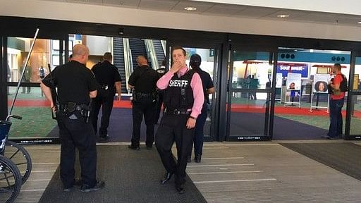Police officers gather at a terminal at Bishop International Airport, Wednesday morning in Flint. (Photo: AP)