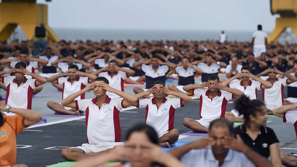 Naval staff performs yoga on board the former warship INS Viraat at the naval dockyard in Mumbai (Photo: PTI)