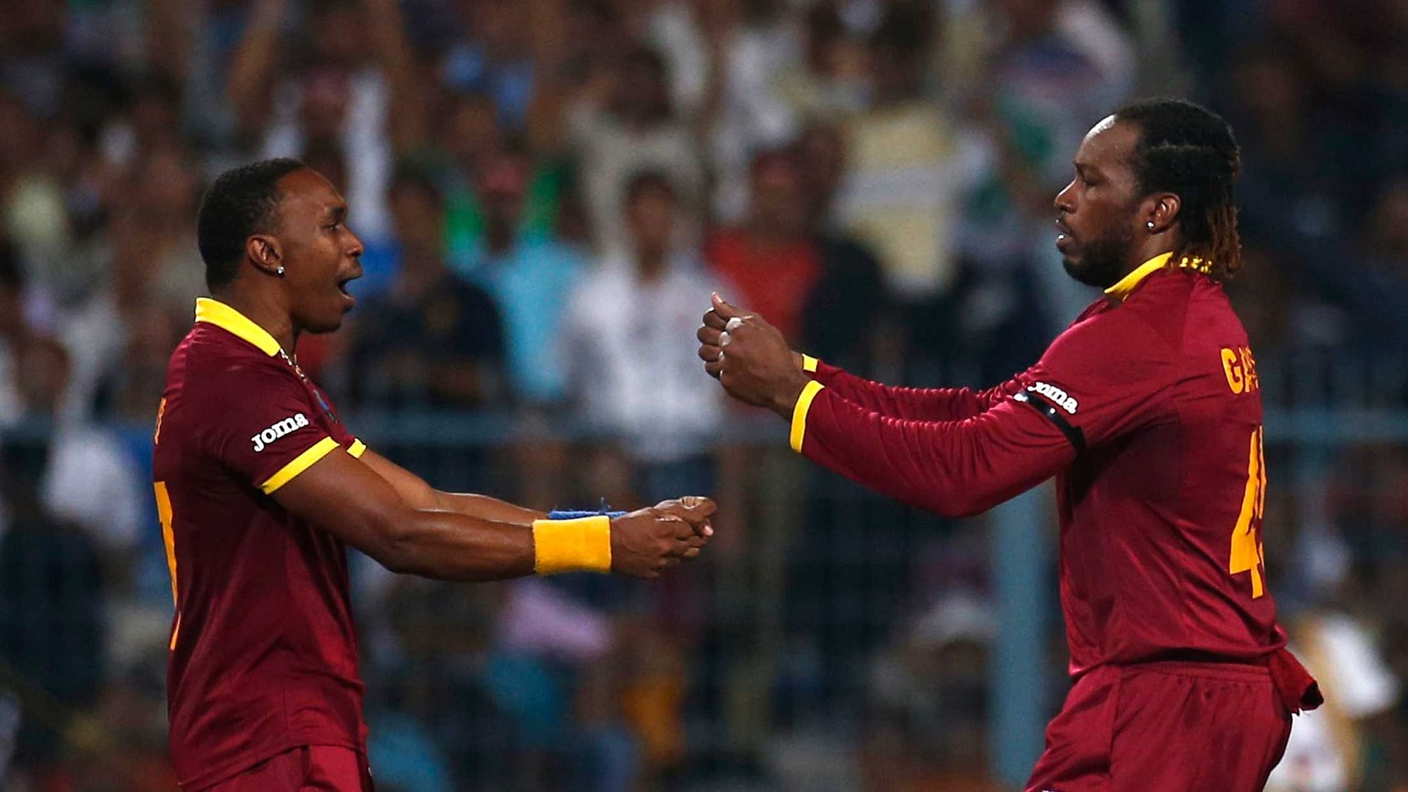 Dwayne Bravo and Chris Gayle celebrate a wicket during the ICC World T20 in 2016. (Photo: Reuters)