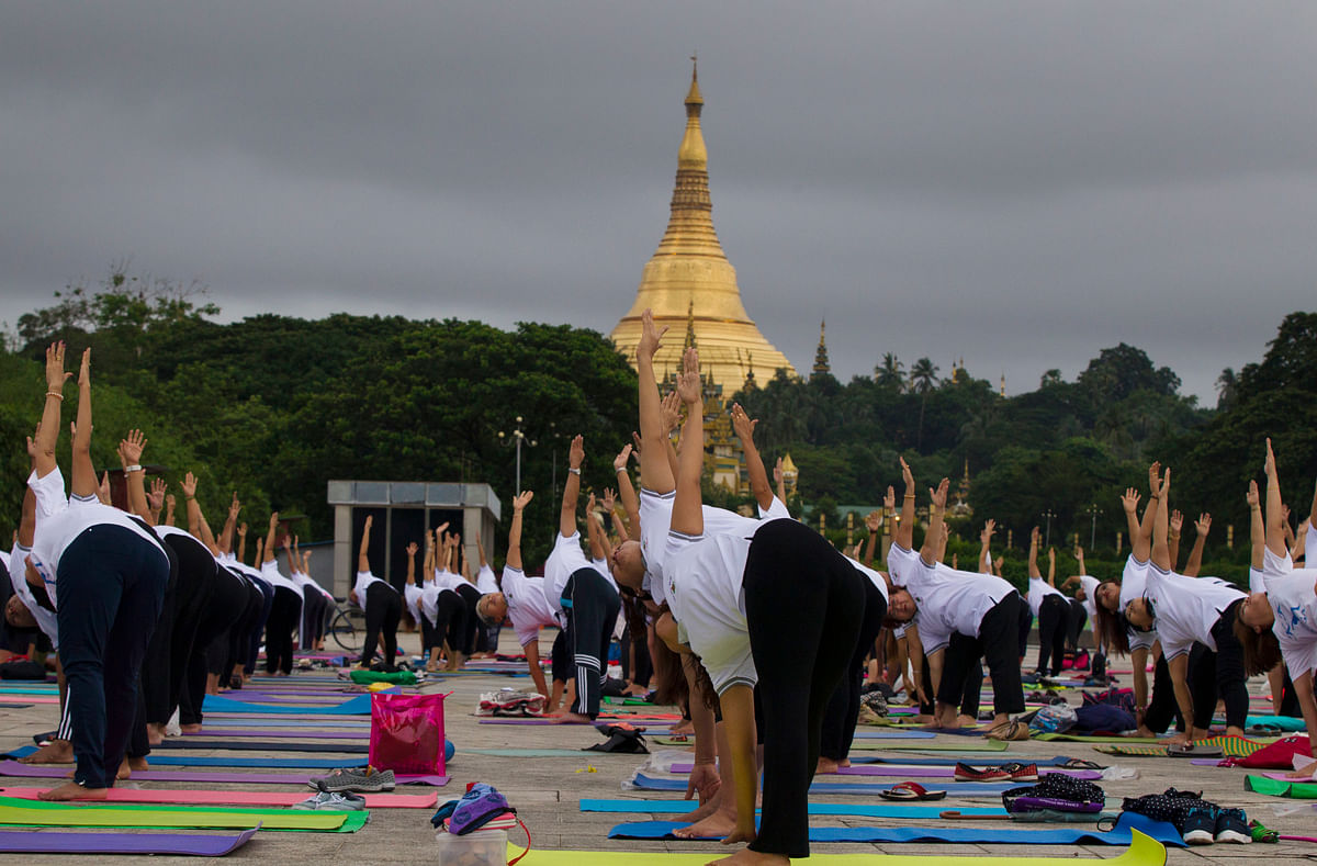 Here is a collection of photos of men and women from around the world practicing yoga at various locations.
