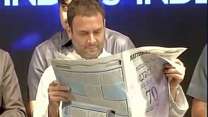 Rahul Gandhi reading National Herald during the launch of the newspaper in Bengaluru last week. (Photo Courtesy: <a href="https://twitter.com/CTRavi_BJP/status/874277300807663618">Twitter</a>/Screengrab)