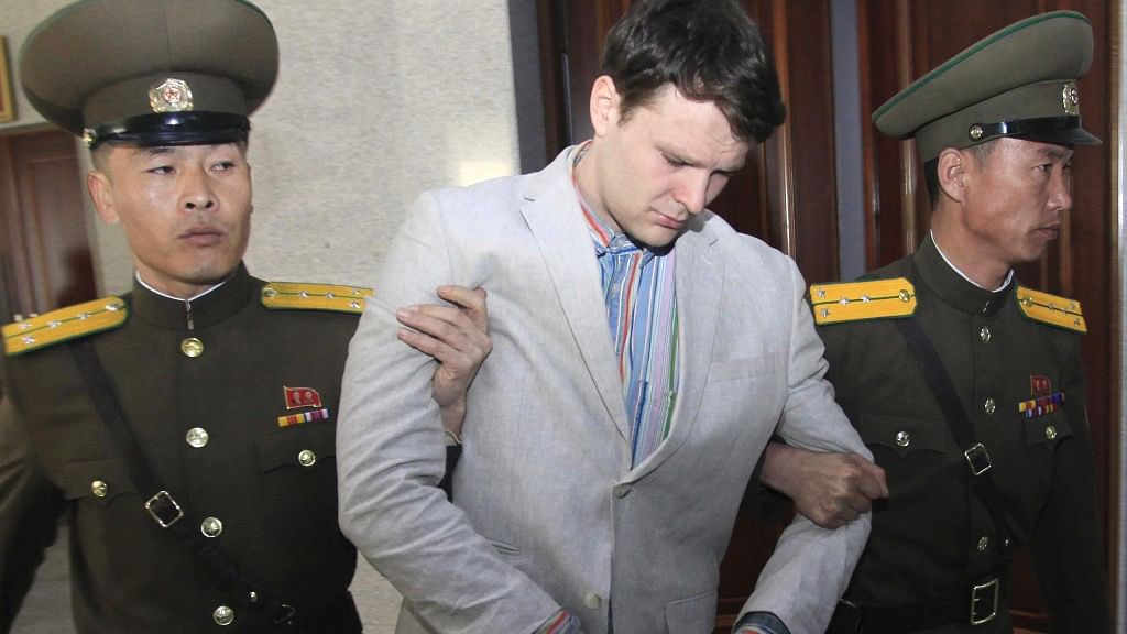 American student Otto Warmbier, center, being escorted at the Supreme Court in Pyongyang, North Korea on 16 March 2016. (Photo: AP)