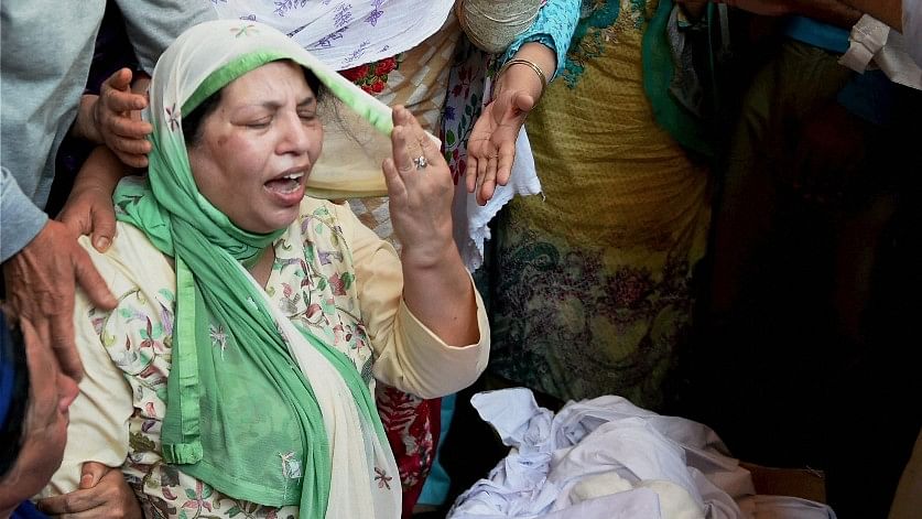 Relatives wailing near the coffin of slain DSP Mohammad Ayub Pandith at his residence in Srinagar on Friday. The officer was lynched to death by a mob outside historic Jamia Masjid in downtown Srinagar during the wee hours of Friday.