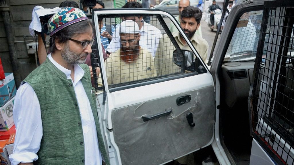  Jammu and Kashmir police detain JKLF chairman Mohammad Yasin Malik while he was going for a joint separatist meeting in Srinagar on Monday. (Photo: PTI)