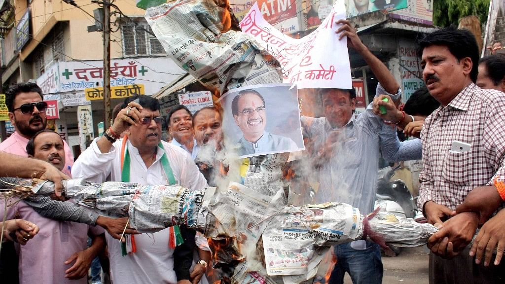 Madhya Pradesh Congress party activists burn effigy of Chief Minister Shivraj Singh Chouhan in Bhopal on Wednesday. (Photo: PTI)