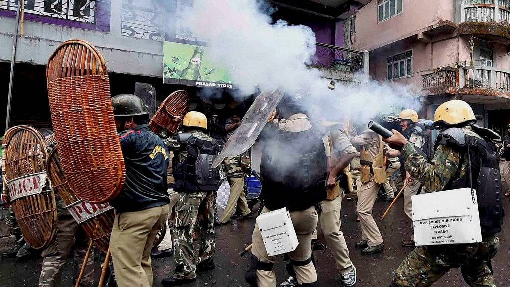 

Security personnel fire tear gas during a protest by Gorkha Janmukti Morcha (GJM) activists in Darjeeling on Saturday (Photo: PTI)