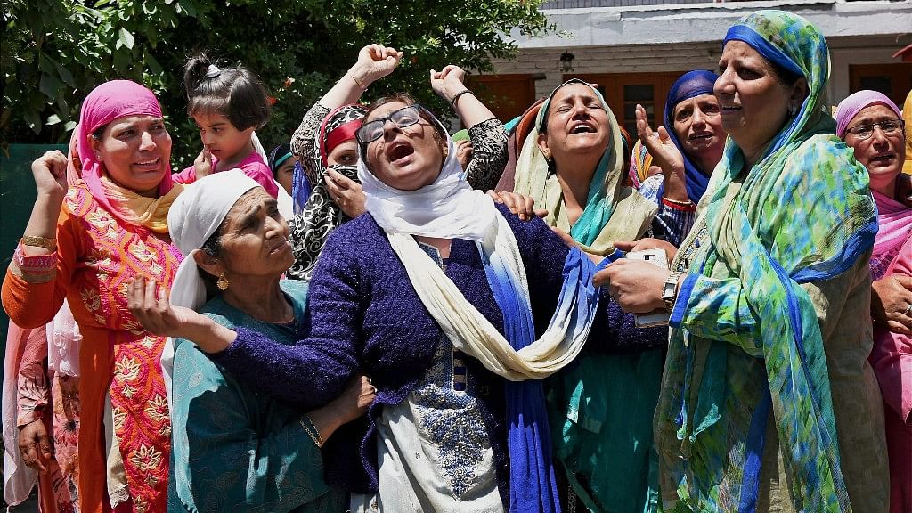 Family members and relatives mourn the death of Mohammed Ayub Pandith at his residence in Srinagar on Friday. (Photo: PTI)