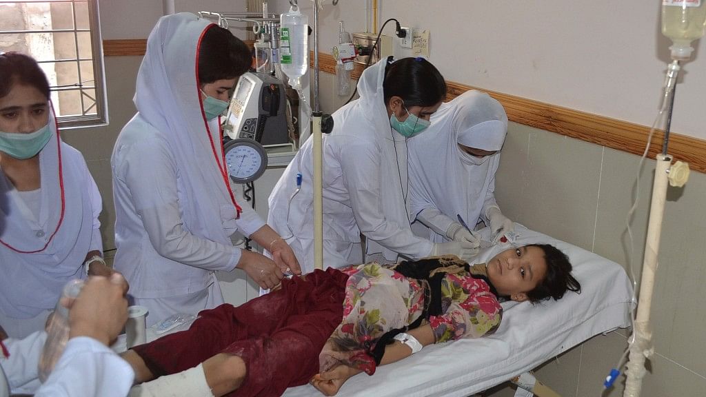 Pakistani nursing staff attend an injured girl at a hospital in Quetta, Pakistan, Friday. (Photo: AP)