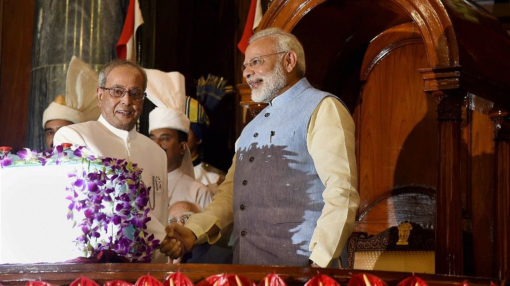 

President Pranab Mukherjee and Prime Minister Narendra Modi shake hands after the launch of Goods and Services Tax (GST).