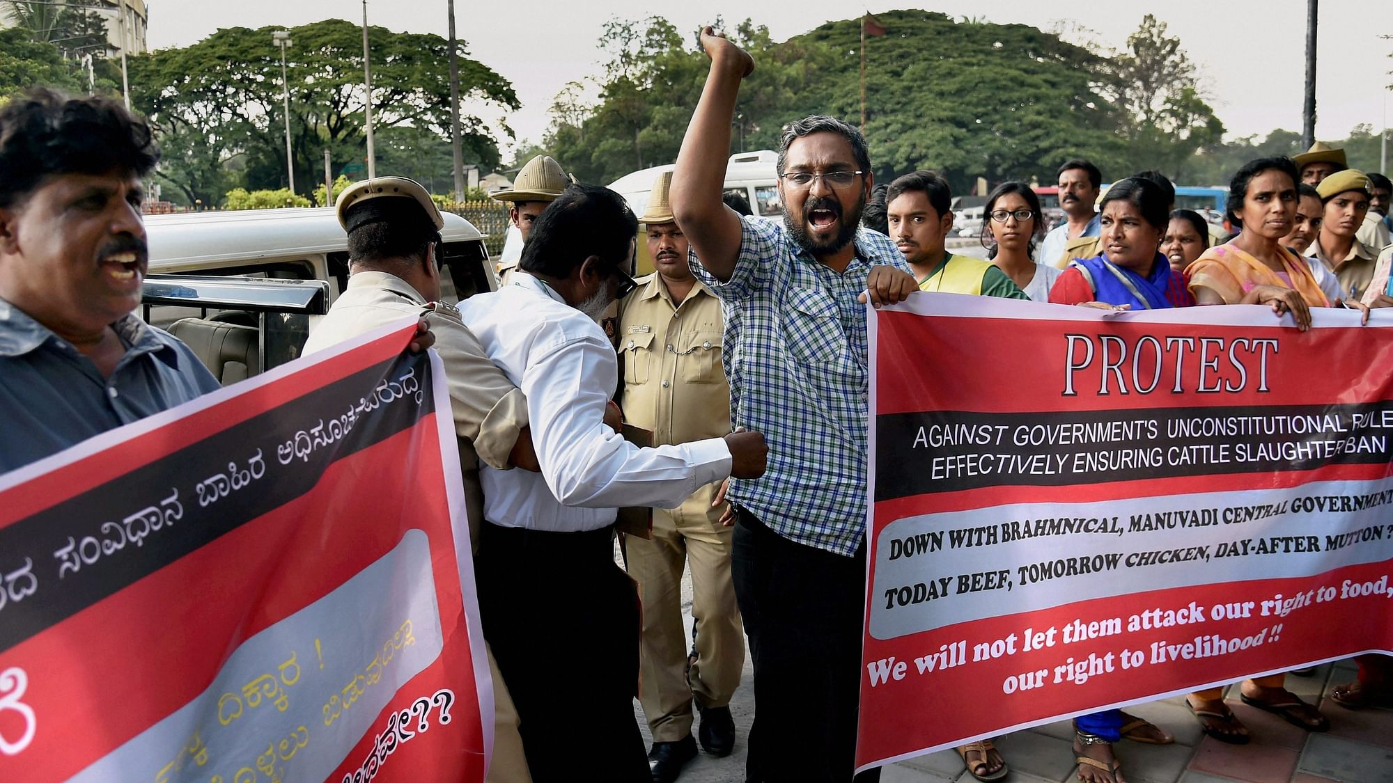 Police detain activists protesting against the Central government’s notification banning sale and purchase of cattle for slaughter  in Bengaluru. (Photo: PTI)