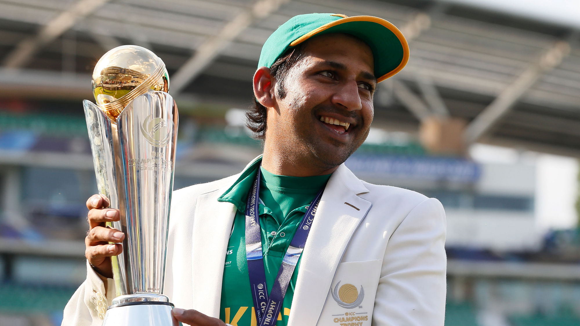 Pakistan’s Sarfaraz Ahmed poses with the ICC Champions Trophy.