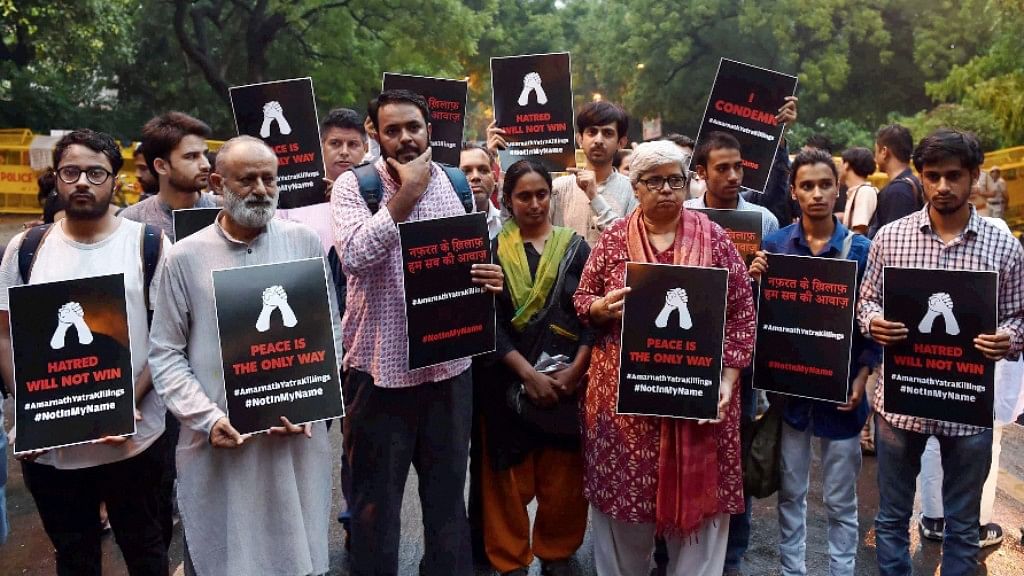 Activists display placards during a ‘Not In My Name’ protest to condemn the militant attack on a bus in which seven Amarnath pilgrims were killed, in New Delhi on Tuesday.