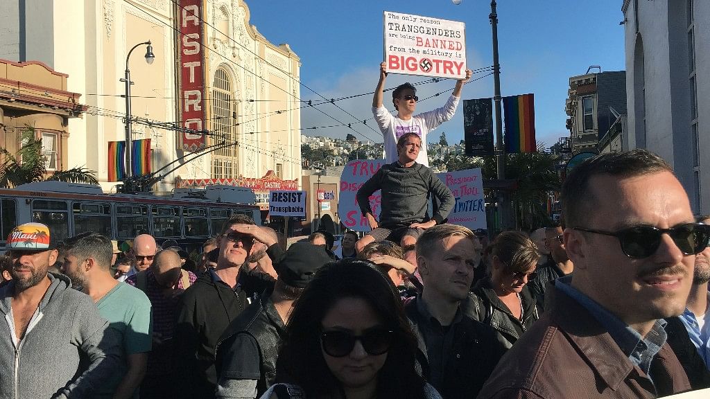Protesters listen to speakers at a demonstration against the proposed ban of transgendered people in the military in the Castro District.