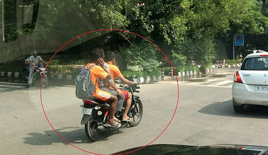 Triple riding, riding without helmet are two clear violations in this photo. 