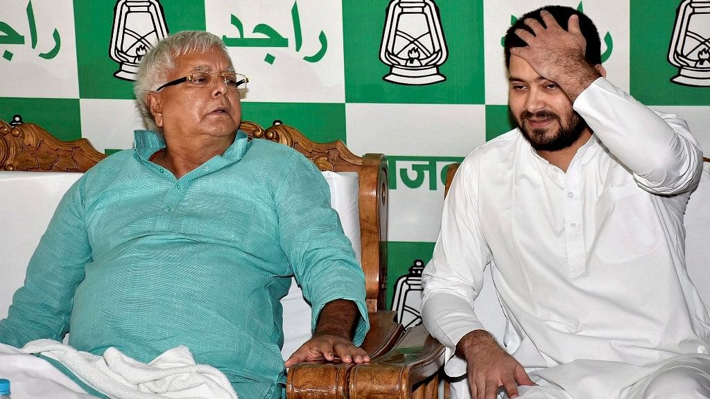 

RJD Chief Lalu Prasad Yadav with his son and Bihar Deputy Chief Minister Tejaswi Yadav during a press conference in Patna on Wednesday
