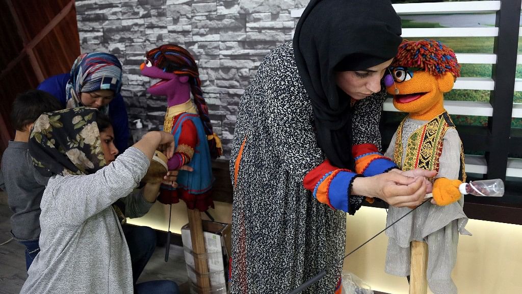 Afghan puppeteers setting props for Sesame Street’s new Afghan character, a 4-year-old Afghan puppet boy called Zeerak.