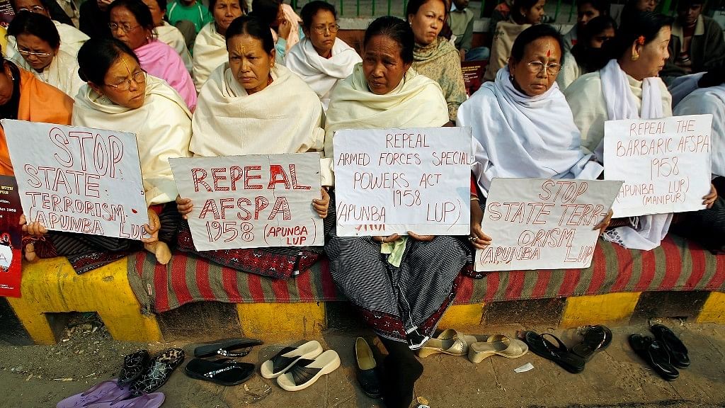 Women hold placards during a protest against the Armed Forces Special Powers Act.