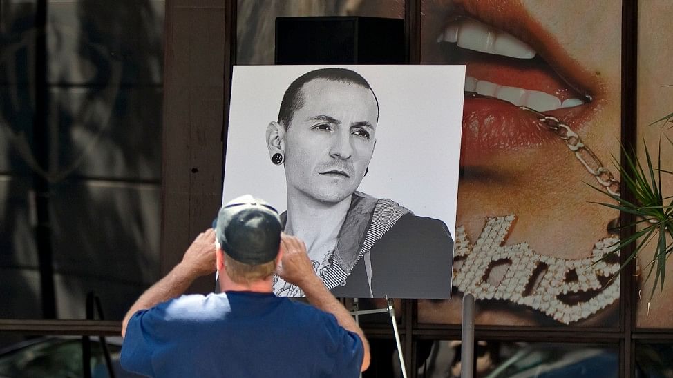  Fan David Gardner takes pictures of photographs of singer Chester Bennington,  displayed at the Warner Bros. Records offices in Burbank, California, 21 July 2017.
