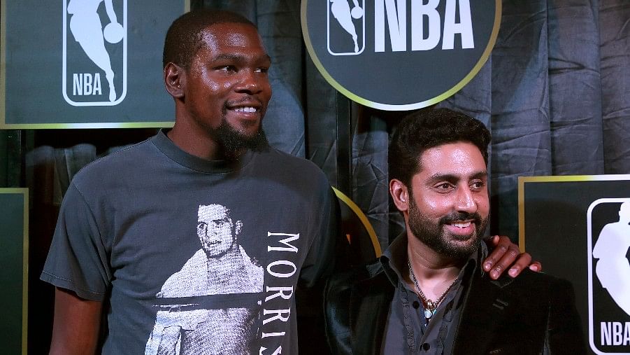 Kevin Durant (L) and Abhishek Bachchan (R) pose for a photograph during an event in New Delhi.