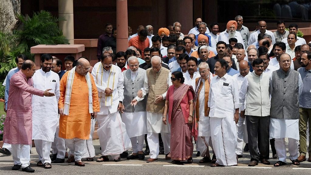 Prime Minister Narendra Modi surrounded by his Cabinet ministers and seniors BJP members.