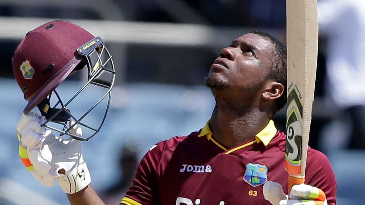 File photo of West Indies cricketer Evin Lewis celebrating after scoring a century in the one-off T20 against India.