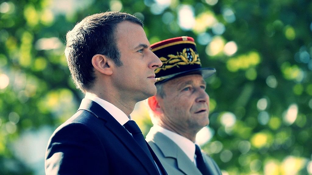 President Emmanuel Macron stands in the command car with France’s military chief during the annual Bastille Day military parade on the Champs Elysees avenue in Paris.&nbsp;