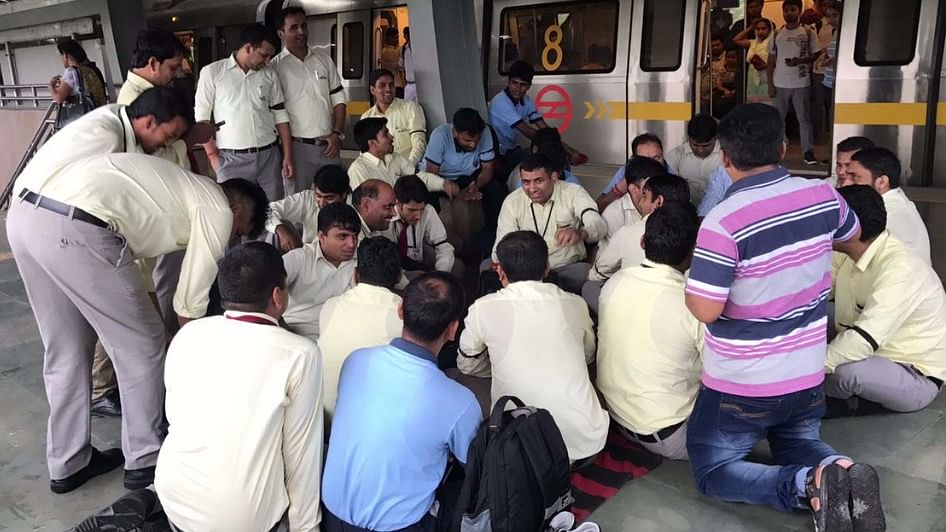 DMRC officials sit on strike at Yamuna Bank metro station on Saturday.&nbsp;