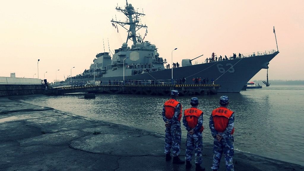 Chinese People’s Liberation Army (PLA) navy soldiers (front) stand guard as USS Stethem (DDG 63) destroyer vessel arrives at a military port for an official visit, in Shanghai, China, 16 November 2015.