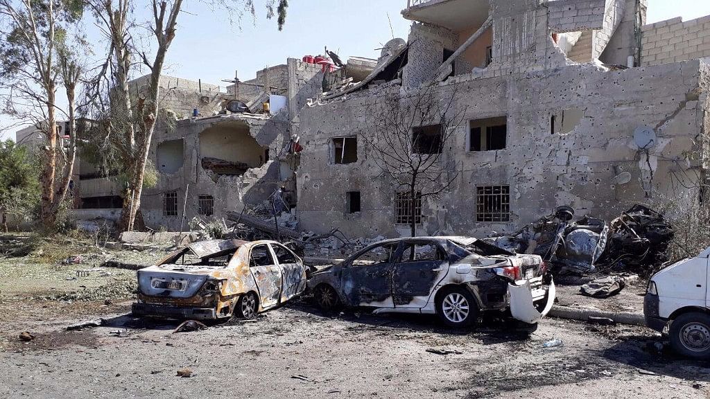 In this photo released by the Syrian official news agency SANA, shows several damaged cars along the road to the airport in southeast Damascus, Syria, on Sunday.