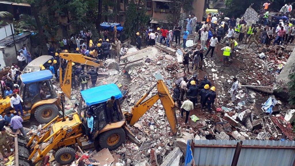  Rescue operations underway at the site where two wings of a four-storey building collapsed