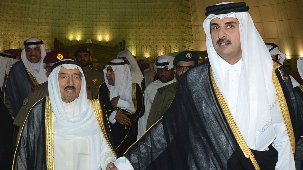 In this photo released by Kuwait News Agency, KUNA, Kuwait’s Emir Sheikh Sabah Al Ahmad Al Sabah, left, holds the hand of Qatar’s Emir Sheikh Tamim bin Hamad Al Thani in Doha, Qatar.
