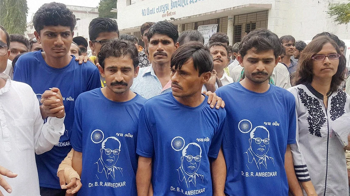 Four Dalit men who were attacked by cow-vigilantes arrive to take part in a solidarity rally in Una, Gujarat, on 15 August 2016. 