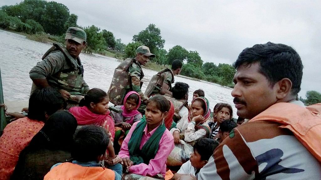 Indian Army personnel rescue and bring to safety stranded flood victims from flooded areas in Banashkantha district of Gujarat.