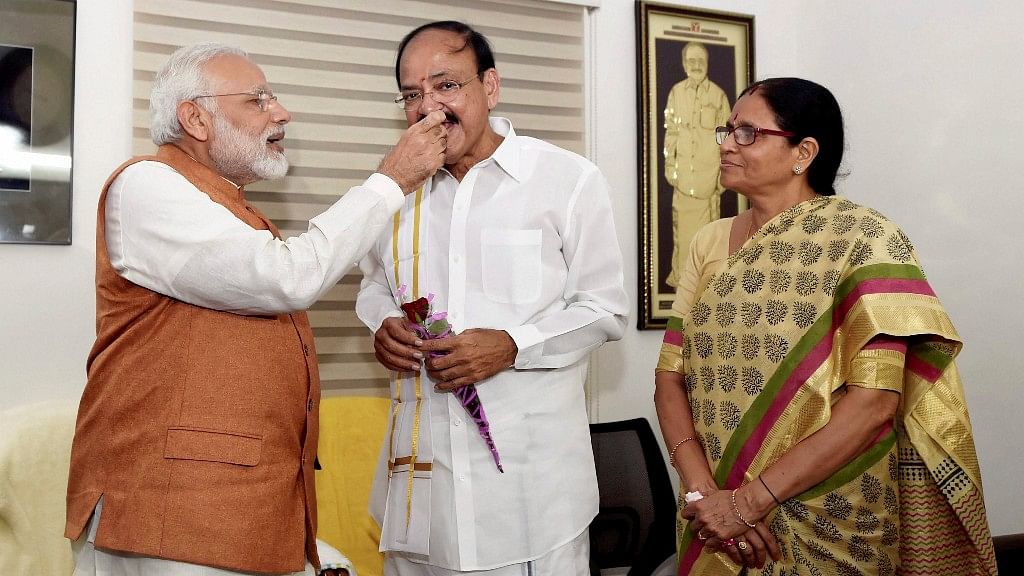 Prime Minister Narendra Modi offers sweets to Vice President elect Venkaiah Naidu at his residence in New Delhi.