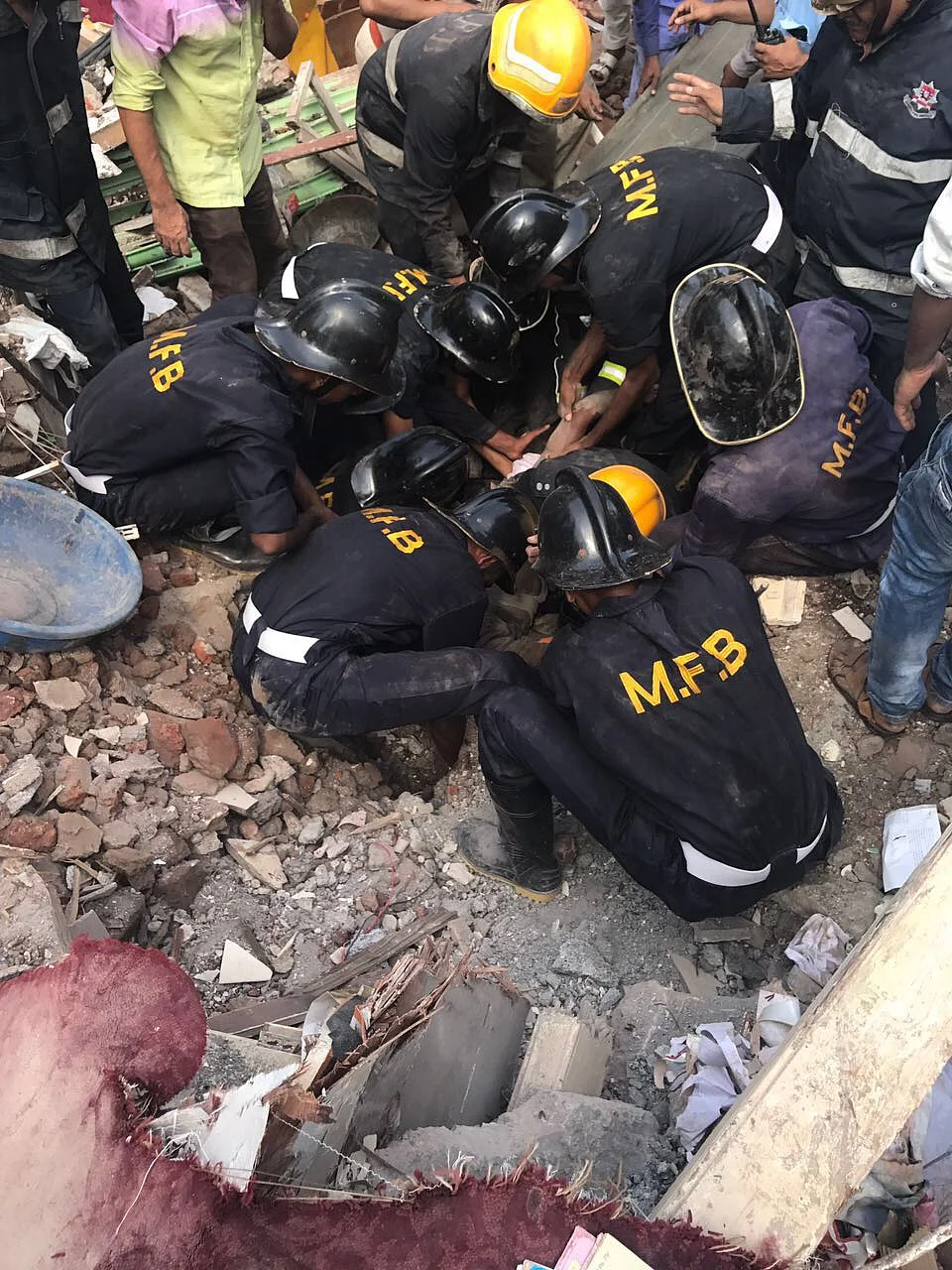 Rescue operations underway at the site of the building collapse.
