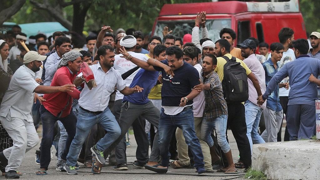 Supporters of the Dera Sacha Sauda attack a member of the media (in dark blue t-shirt) in Panchkula on Friday.