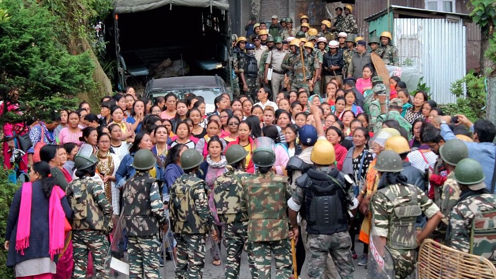 Security forces personnel trying to control woman Gorkha Janamukti Morcha (GJM) supporters during a protest  in Darjeeling.