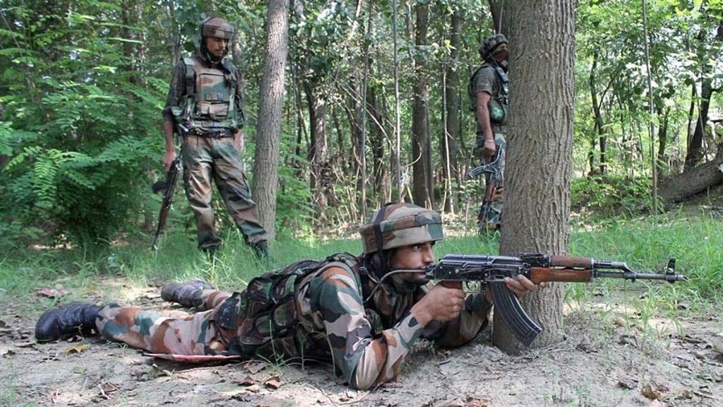 Security personnel take positions during an encounter in Pulwama.